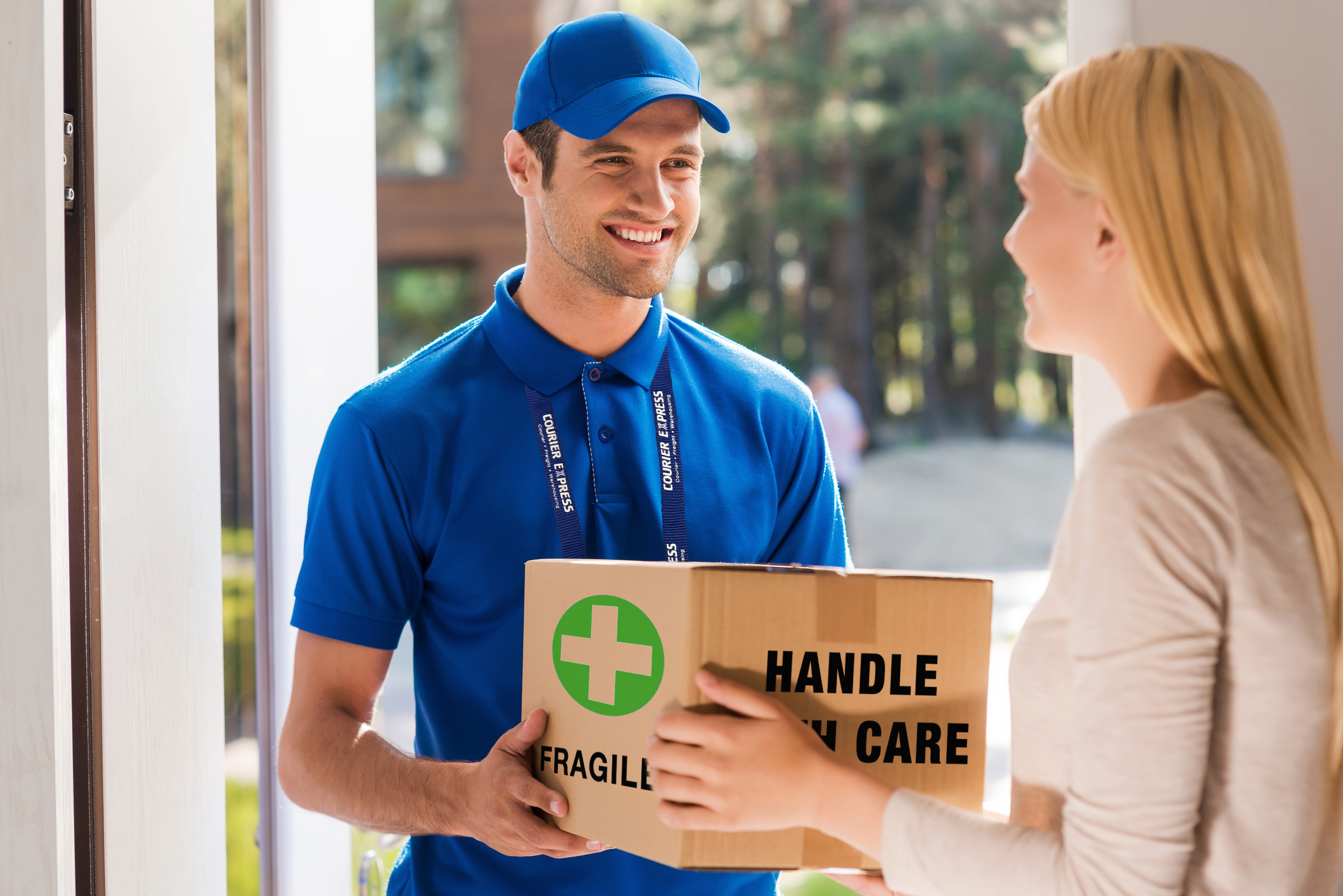 Courier with health care package at resident’s door